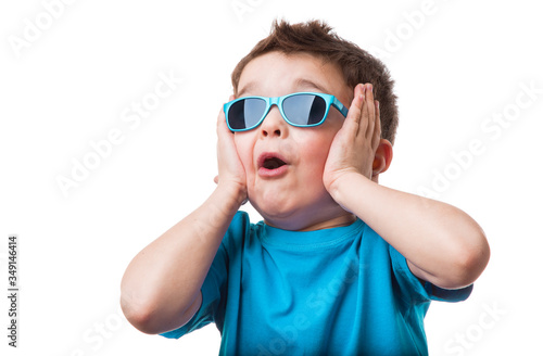 Cheerful little boy in sunglasses express surprised face, isolated on white background