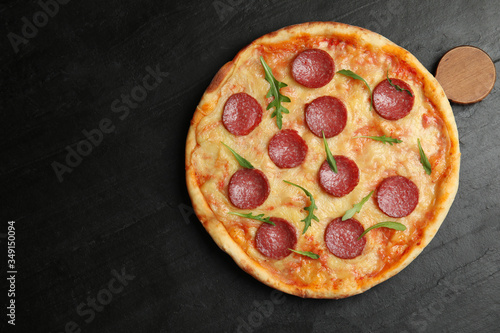 Tasty pepperoni pizza on black table, top view