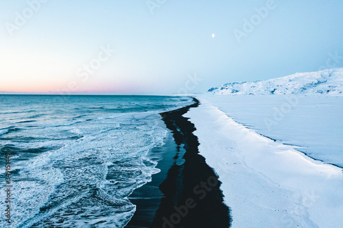 Overhead Aerial Shot of Beautiful Black Beach in Iceland in Winter with Snow