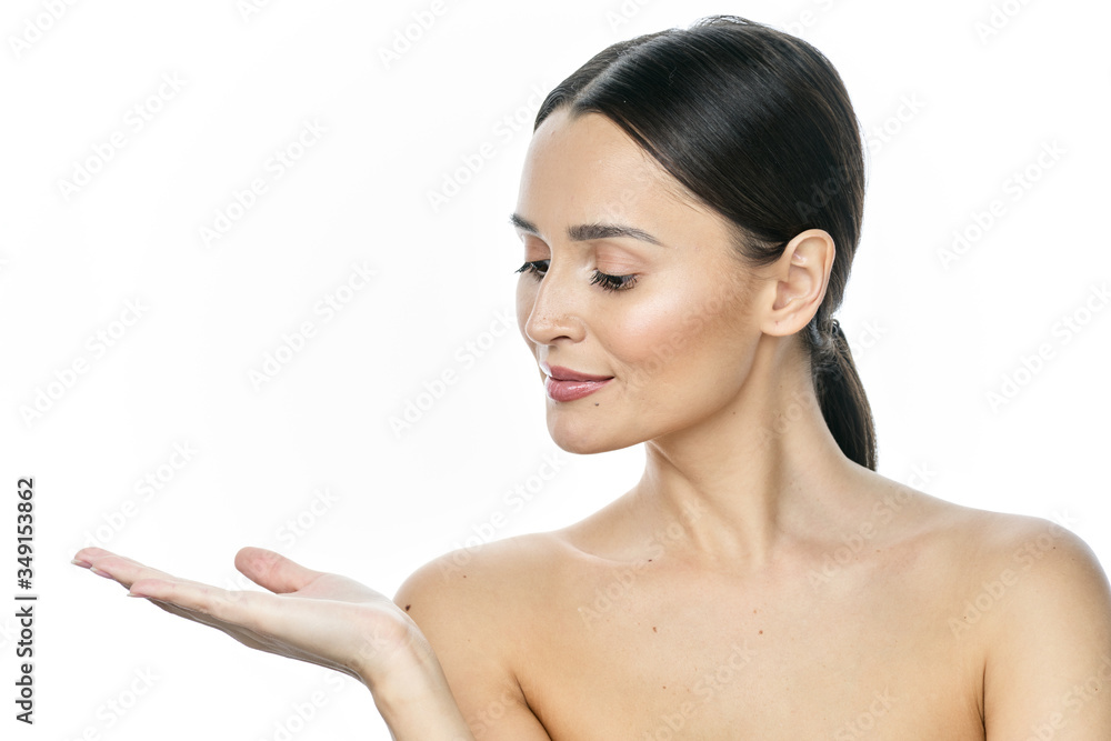 Photo of happy young woman standing isolated over white wall background. Looking camera showing copyspace pointing. Photo of happy young woman standing isolated over white wall background. Looking camera showing copyspace pointing.