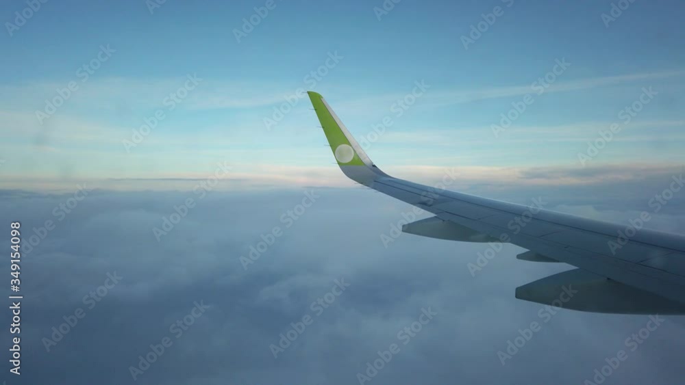 The plane is reduced from a height, the flight passes over the top edge of the clouds. The plane is reduced from a height, the flight passes over the top edge of the clouds.