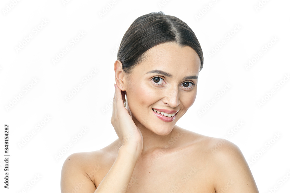 Beautiful smiling woman with clean skin, natural make-up, and white teeth on white background