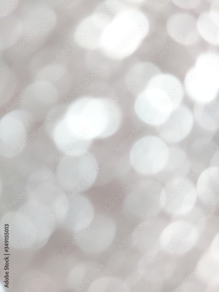 White and silver blur abstract background with bokeh lights for background 