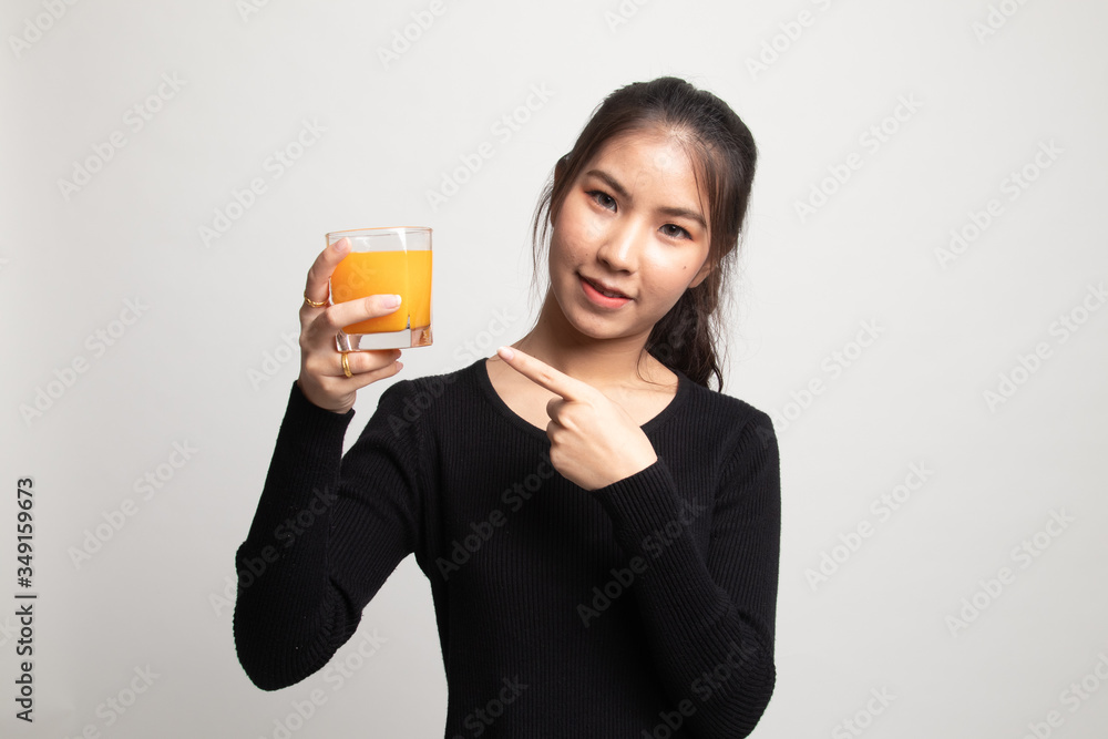 Young Asian woman point to orange juice. Young Asian woman point to orange juice.