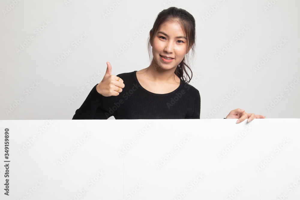 Young Asian woman show thumbs up with blank sign. Young Asian woman show thumbs up with blank sign.