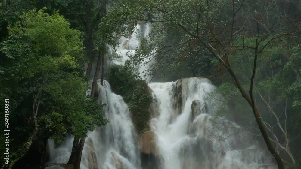 Tropical rainforest waterfalls after rain in monsoon season nature background, high humidity forest around Tat Kuang Si waterfalls or Kuang Si falls in Luang Prabang, Laos. Tropical rainforest waterfalls after rain in monsoon season nature background, high humidity forest around Tat Kuang Si waterfalls or Kuang Si falls in Luang Prabang, Laos.