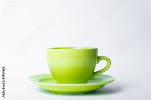 green cup on a white background