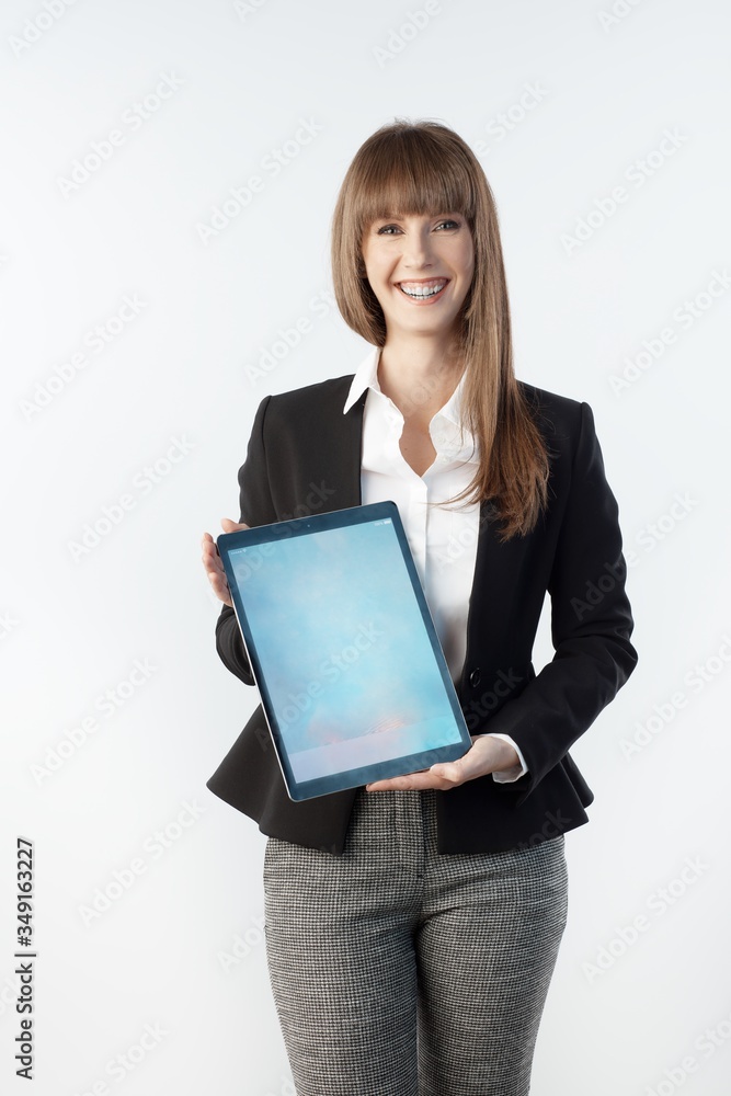Happy white young businesswoman showing large business tablet with blank screen. Woman with happy smile, isolated on white. Happy white young businesswoman showing large business tablet with blank screen. Woman with happy smile, isolated on white.