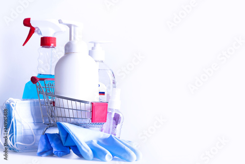 Shopping basket full with disinfection or disinfection cleaning products on white background