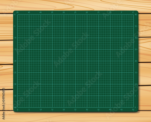 Cutting Mat on wood texture background. Green Cutting Mat.