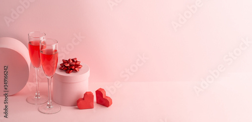 Round gift box, red hearts and glasses of sparkling wine