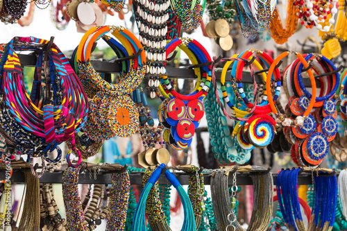 African traditional bead necklaces or beadwork hanging up in a market stall
