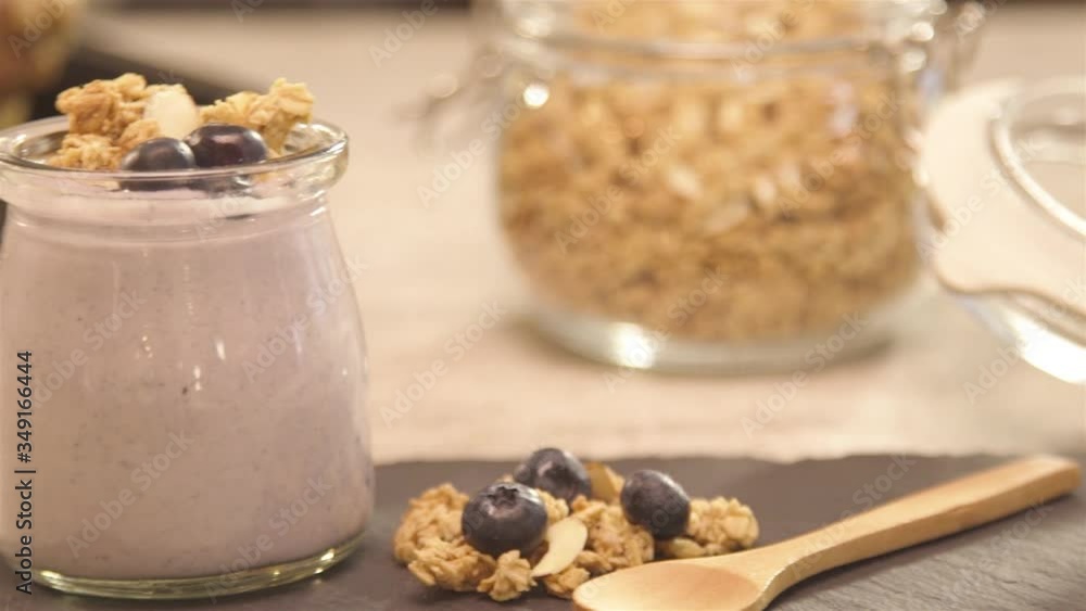 a glass of yogurt next to blueberry - slide left a glass of yogurt next to blueberry - slide left