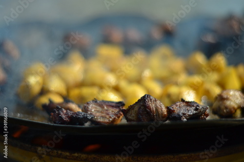 Potato and meat dish on fire