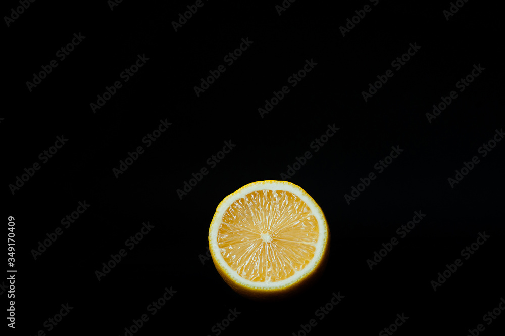 half a juicy yellow ripe fresh lemon on a pure black background half a juicy yellow ripe fresh lemon on a pure black background