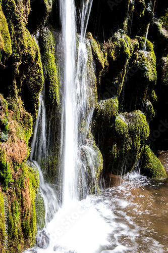 Beautiful small waterfall in the forest. Closeup.