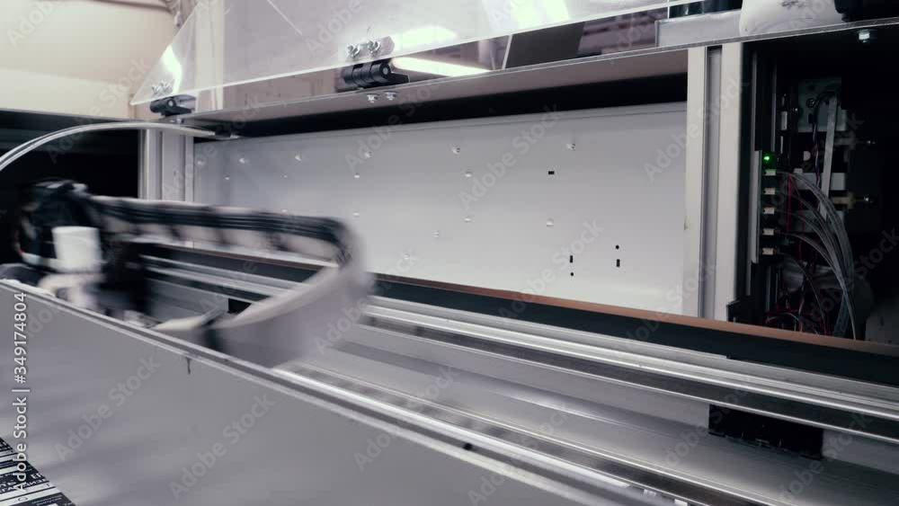 Moving print head of a large printing press. Moving print head of a large printing press.