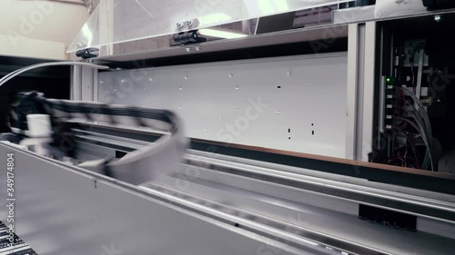 Moving print head of a large printing press.