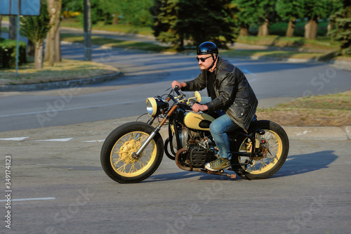 A view of a young man riding a motorcycle on an open road