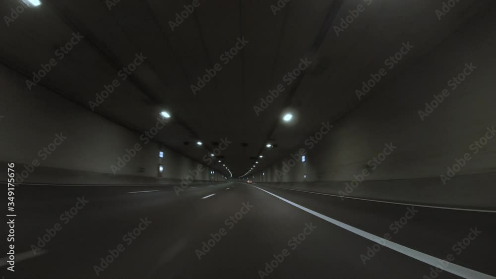POV, Driving Plate - car driving fast through a long tunnel with interior lights, shot by night. POV, Driving Plate - car driving fast through a long tunnel with interior lights, shot by night.