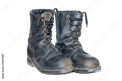 old soldier's boots worn with scratches and untied shoelaces. Old shabby leather boots isolated on white background. old leather military boots isolated on white background.