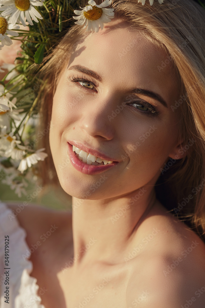 Closeup portrait of a beautiful blonde in a chamomile field. Closeup portrait of a beautiful blonde in a chamomile field.