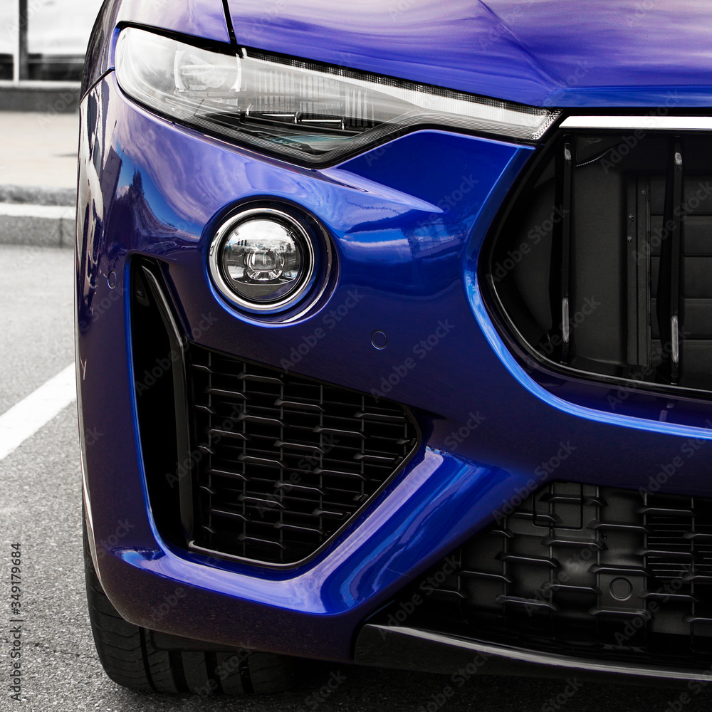 Part of a blue car close up. Car headlights. Luxury Headlights