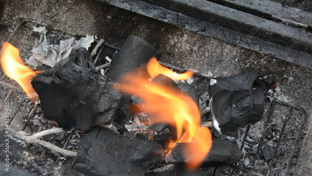 Beautiful red fire from dark grey black coals inside metal brazier. Beautiful red fire from dark grey black coals inside metal brazier.