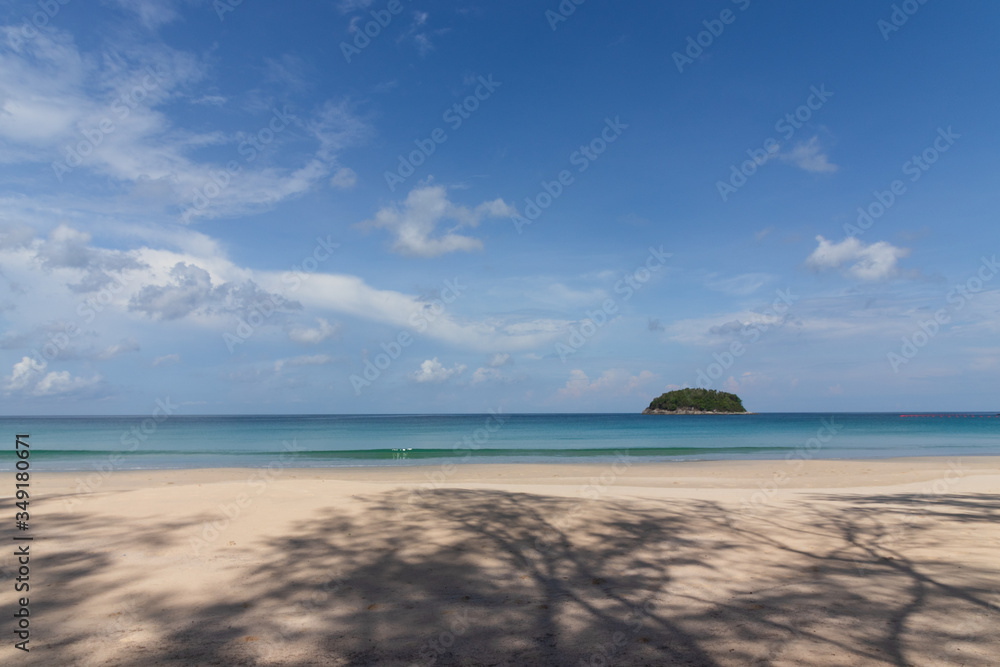 beautifull empty beach with small island in the blue sea and clear sky