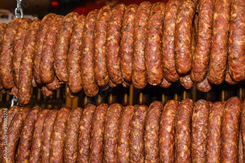 Many homemade German mix of meat specialties, speck ham sausages pile or stack on counter top