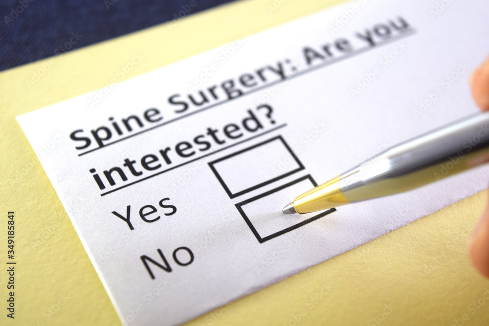 Obraz premium One person is answering question about spine surgery.