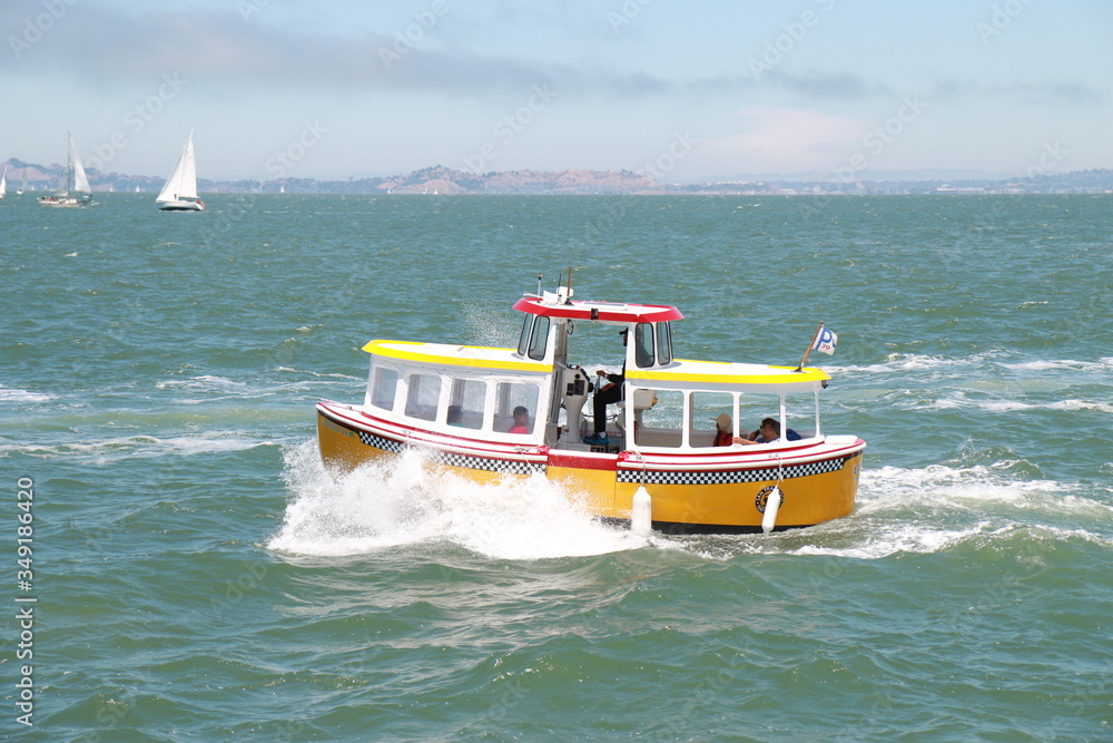 Fototapeta premium yellow small boat sailing in the sea