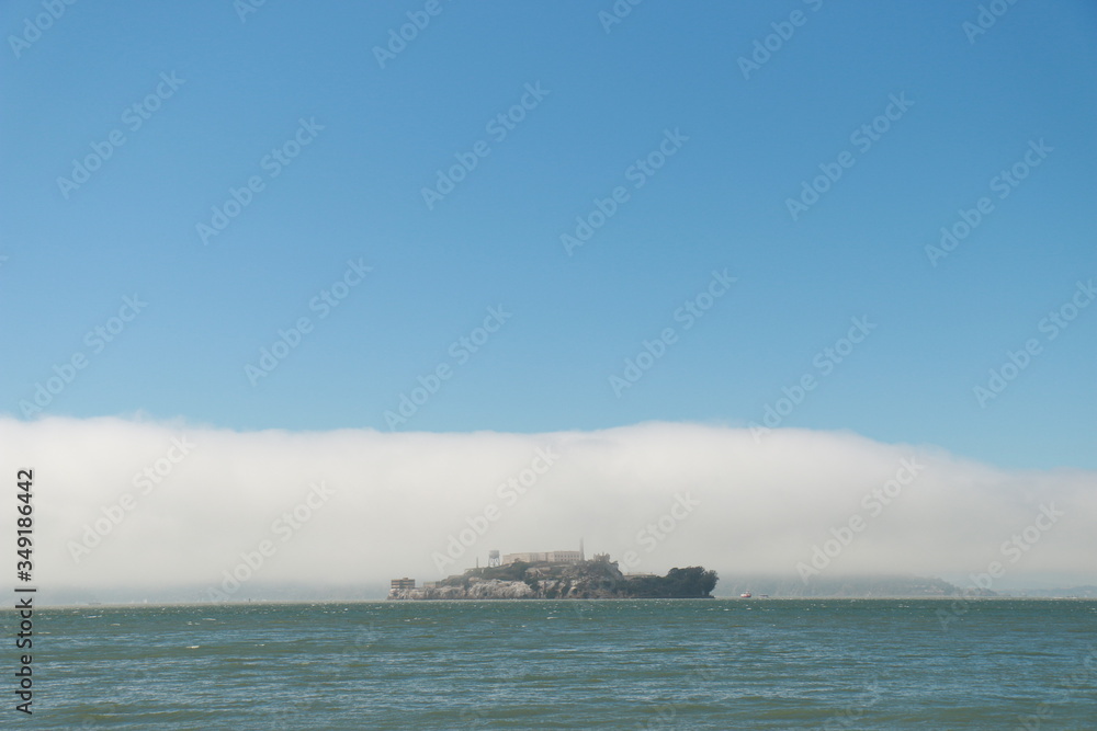 island in the sea with cloud and blue sky