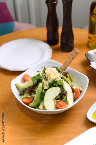 avocado, tomato, lettuce, green apple, mixed salad ready for presentation photo