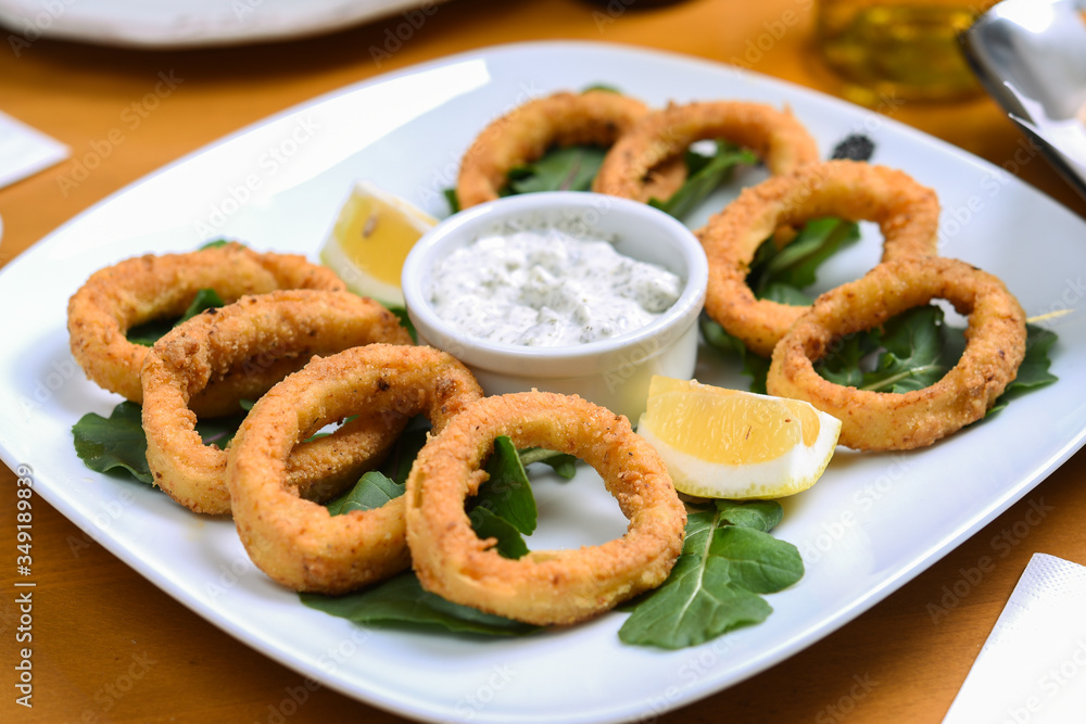 snack onion rings and sauce on pieces of greens snack onion rings and sauce on pieces of greens