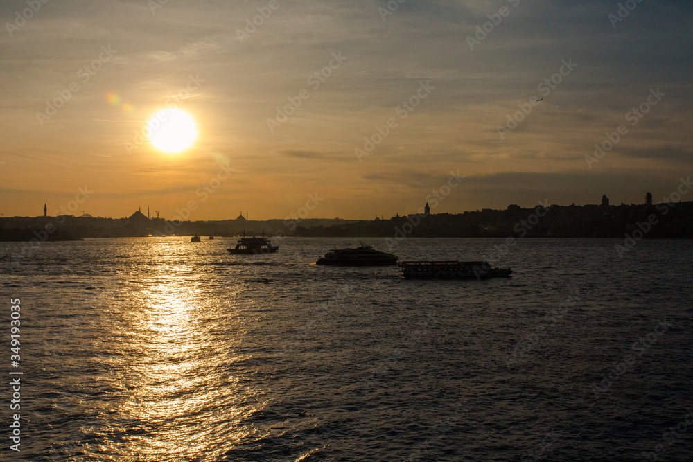 Silhouette of a boats in the Bosphorus on the background of Istanbul at sunset. Turkey