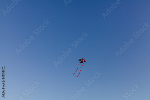 Flying kite in the form of an airplane in the sky
