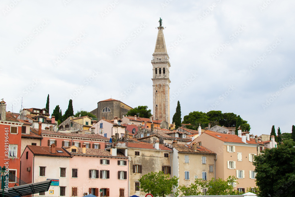 Old town of Rovinj, Croatia, with the facades of the typical croatian houses and the Church of St. Euphemia (also known as Basilica of St. Euphemia) on the top