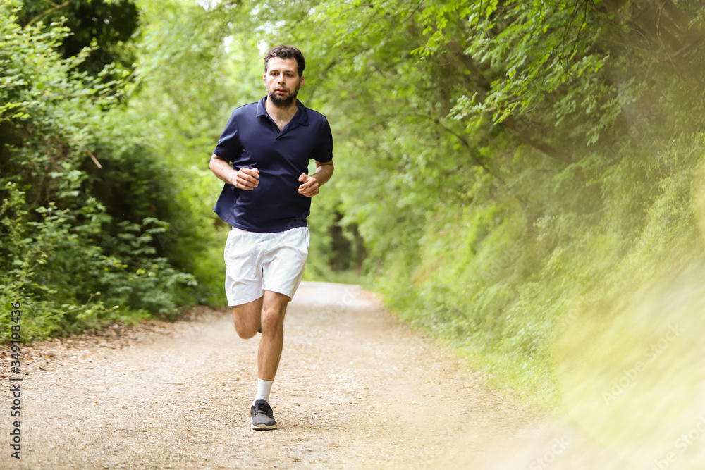 Sports activity during coronavirus. Runner wearing a medical mask, Covid-19 pandemic. Active life in quarantine, protection for face mask. Outdoor ride on countryside. Sports activity during coronavirus. Runner wearing a medical mask, Covid-19 pandemic. Active life in quarantine, protection for face mask. Outdoor ride on countryside.