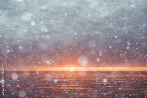 abstract blurred background, snow falls on the sea, northern cold sea, climate winter view