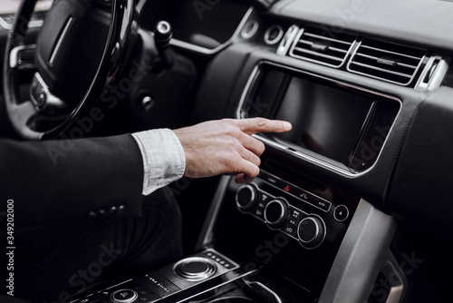 Close up of male hand using car dashboard