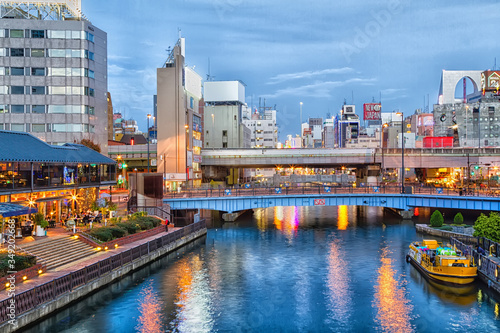 OSAKA, JAPAN - NOVEMBER 15: Dotonbori Canal is a manmade waterway dug in the early 1600's and now displays many landmark commercial locals and vivid neon signs on November 15, 2015 in Osaka, Japan. photo