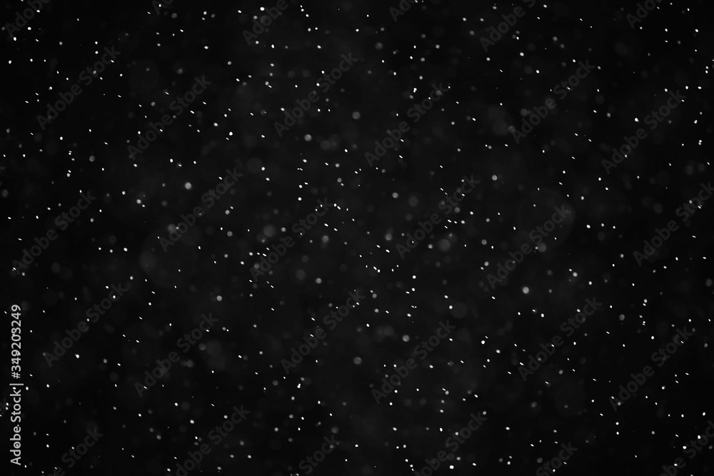 Obraz premium snow black background abstract texture, snowflakes falling in the sky overlay