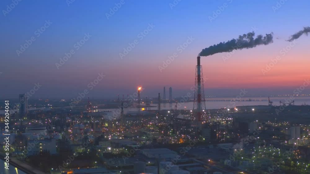 Factories and production plants at dusk in Yokkaichi, Japan. (aerial photography)