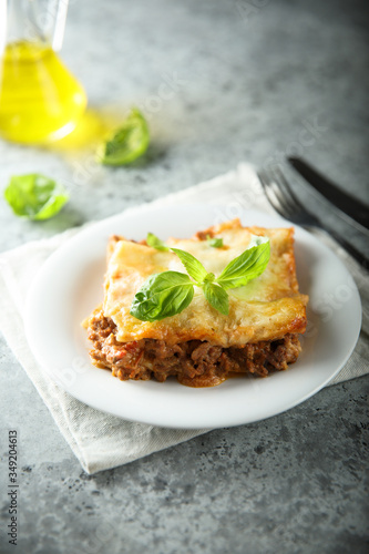 Traditional homemade lasagna served with fresh basil