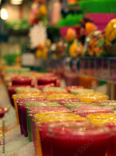 Market booth with colorful fresh juice and smoothies