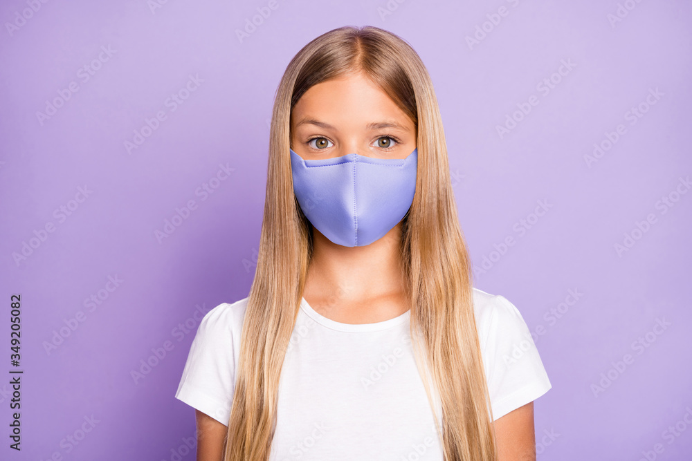 Close up photo of pretty positive cheerful child look have covid-19 quarantine her family friends wear white breathing mask t-shirt clothes isolated over violet color background Close up photo of pretty positive cheerful child look have covid-19 quarantine her family friends wear white breathing mask t-shirt clothes isolated over violet color background