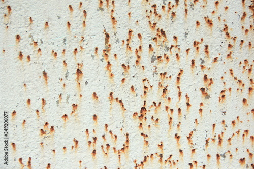 iron panel painted white with rust spots