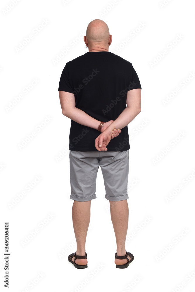 rear view of bald man with sandals t-shirt and shorts on white background, hands crossed rear view of bald man with sandals t-shirt and shorts on white background, hands crossed
