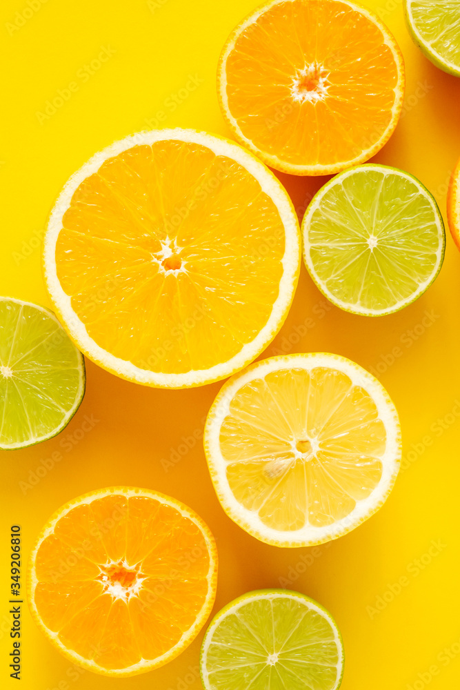 Citrus fruits pattern background, grapefruit, orange, tangerine, lemon, lime on yellow background. Flat lay, top view, copy space Citrus fruits pattern background, grapefruit, orange, tangerine, lemon, lime on yellow background. Flat lay, top view, copy space